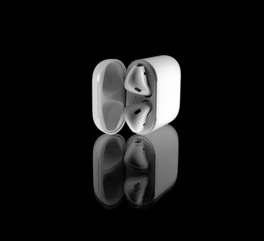 White wireless earbuds with charging case displayed against black background with reflection.
