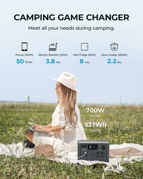 Woman sitting outdoors with portable power station displaying 700W output and 537Wh capacity.