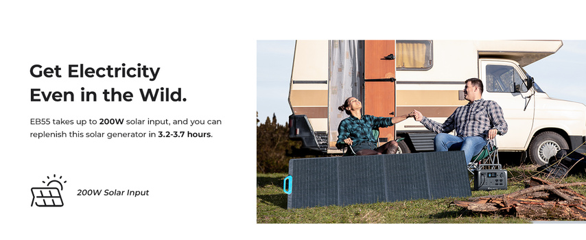 Three people gathered around a portable solar panel near a camper van in a natural outdoor setting.