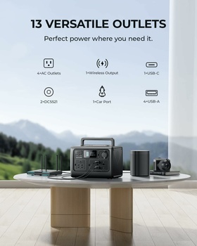 Portable power station and accessories displayed outdoors with mountain landscape backdrop.