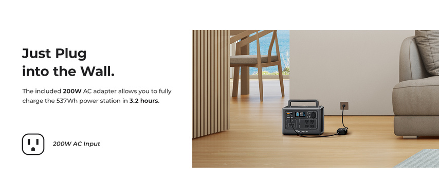 Portable power station plugged into wall outlet in a modern living room.