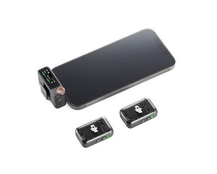 Wireless microphone system with smartphone mount and two compact receiver units arranged on white background.