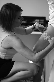 Woman examining a baby's arm during what appears to be a medical or health check appointment.