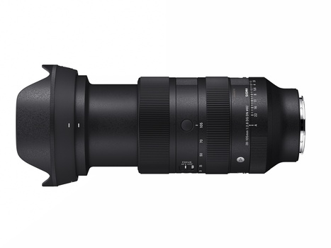 Telephoto zoom lens with hood and focus ring against white background.