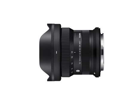 Sigma 20mm f/1.4 DG HSM Art lens with hood attached, shown in profile against white background.