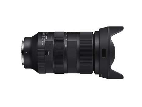 Black telephoto zoom lens with hood mounted on white background.