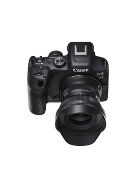 Canon EOS R5 mirrorless camera with RF-mount lens attached, shown from above against white background.