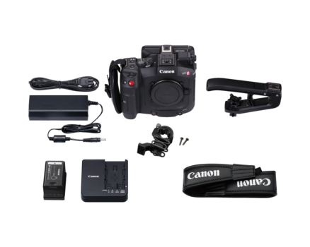 Canon EOS cinema camera with professional video accessories and charging equipment laid out.