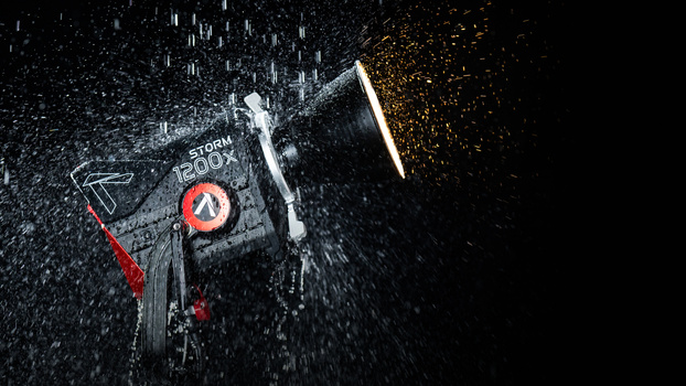 High-speed product photography of a bicycle with water and sparks frozen in motion against a black background.