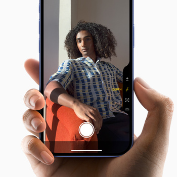 Smartphone screen displaying portrait mode camera interface with subject wearing checkered shirt.