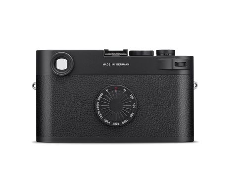 Black rangefinder camera with textured leather body and manual aperture dial on front.