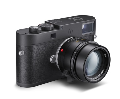 Rangefinder camera with interchangeable lens mounted on textured black body.