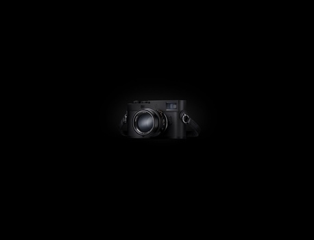 Two professional cameras positioned against a black background, showcasing their front-facing designs and lens elements.