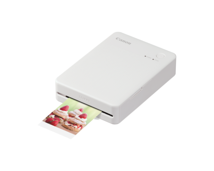 White compact photo printer with a printed photo partially ejecting from the front slot.