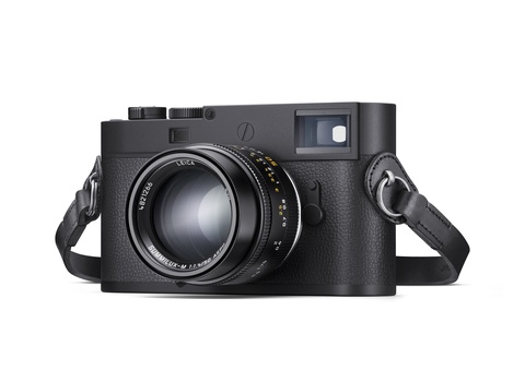 Black rangefinder film camera with attached shoulder strap and fast prime lens.