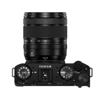 Top-down view of a black mirrorless camera with attached zoom lens and dual control dials.
