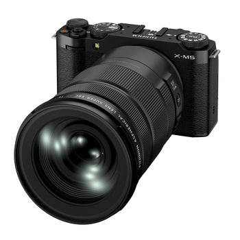 Black mirrorless camera with large telephoto lens attached, displayed against a white background.
