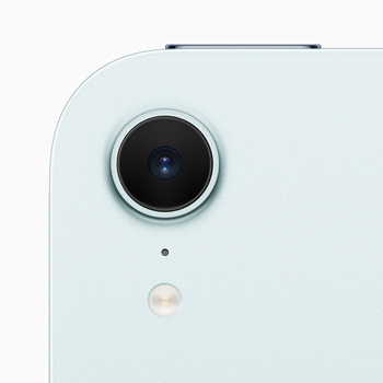 Close-up of a smartphone camera module with a circular lens and flash on a light blue device.