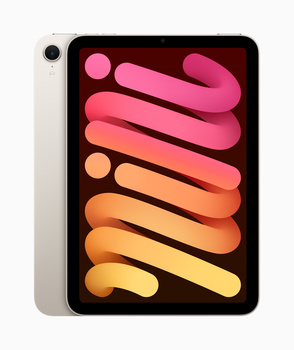iPad mini displaying a gradient wallpaper with curved organic shapes transitioning from pink to yellow tones.
