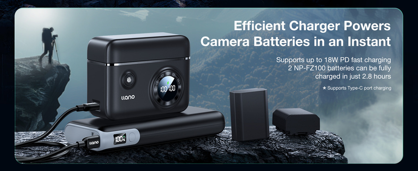 Battery charger with dual battery slots and portable power bank displayed on rocky terrain with mountains in background.