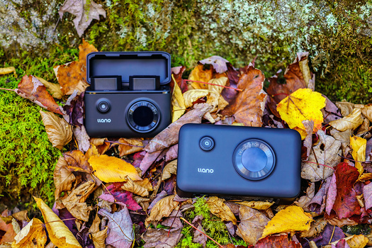 Two Kono instant cameras displayed on moss and autumn leaves.