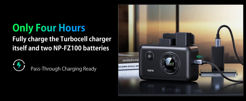 Camera battery charger with two batteries and charging cable displayed on a table at sunset.
