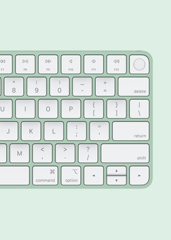 Overhead view of a minimalist wireless keyboard with white keys on a pale green background.