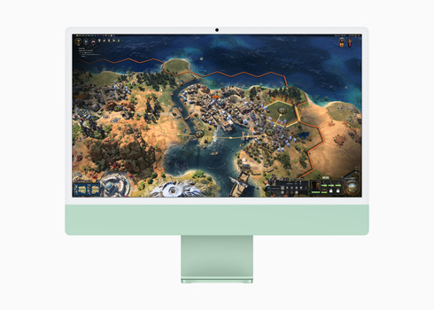 Screenshot of a strategy game displaying an aerial view of a coastal settlement with green monitor frame.