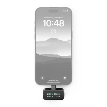 Smartphone displaying a landscape lock screen mounted above a compact wireless transmitter device.