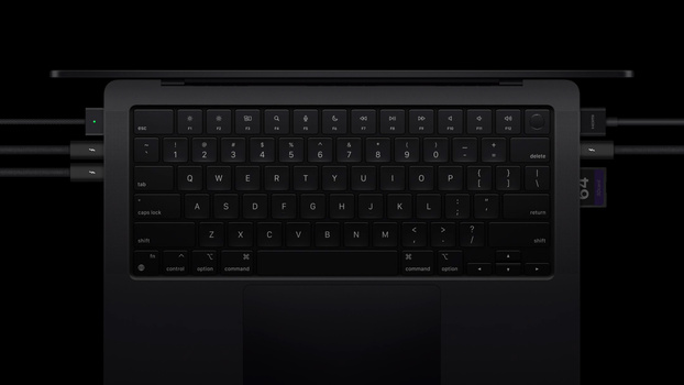 Top-down view of a laptop keyboard illuminated against a dark background.
