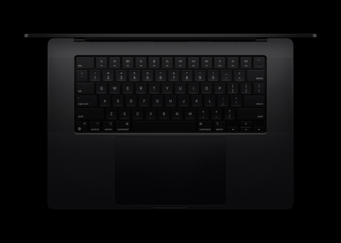 Overhead view of a laptop with dark keyboard and trackpad against black background.