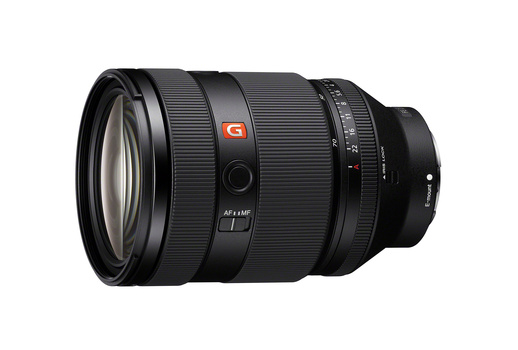 Sony G-series zoom lens with orange badge and focus ring against white background.