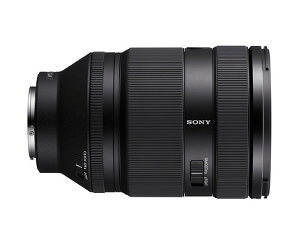 Sony zoom lens with extended barrel against white background.