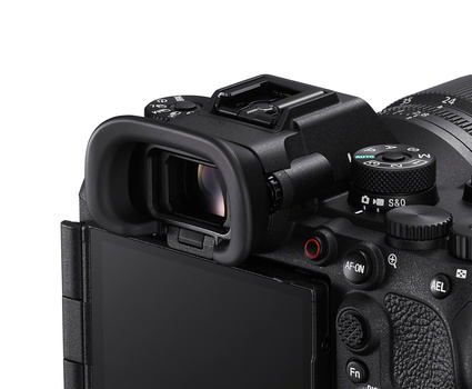 Close-up of a professional video camera's rear LCD screen and electronic viewfinder with control buttons visible.