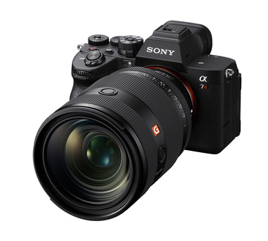 Sony α7 mirrorless camera with attached telephoto lens against white background.