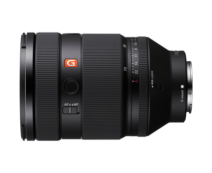 Sony mirrorless camera lens with red badge and ribbed barrel, shown in profile view.