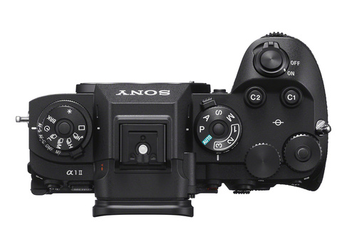 Top-down view of a Sony mirrorless camera body with dual control dials and mode buttons.