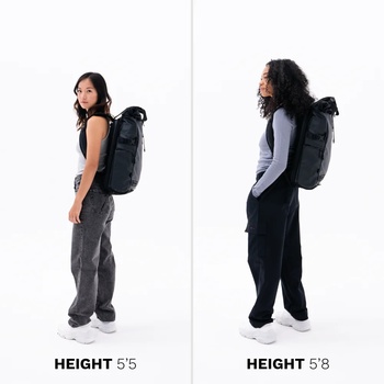Two women of different heights wearing identical black backpacks, demonstrating fit comparison for heights 5'5" and 5'8".