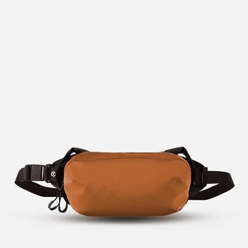 Tan leather fanny pack with black nylon straps and dual carrying handles against white background.
