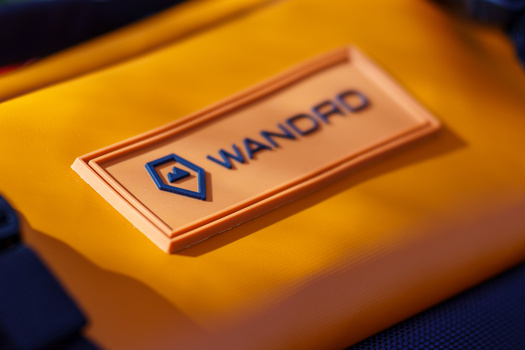 Wancfo brand badge or emblem on yellow surface with blue logo.