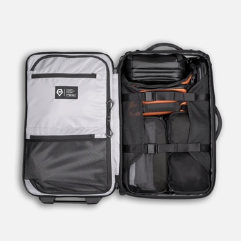 Open travel backpack showing organized compartments with packing cubes and storage sections.