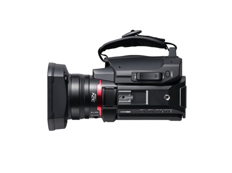 Sony FDR-AX700 4K camcorder with wide-angle lens attachment, shown from the side against a white background.