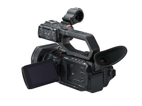 Professional compact camcorder with articulating screen, microphone attachment, and dual SD card slots visible.