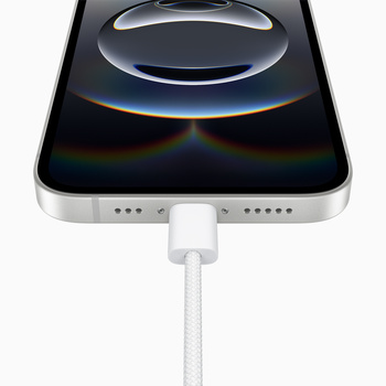 Smartphone with USB-C charging cable connected to bottom port, displaying abstract liquid sphere on black screen.