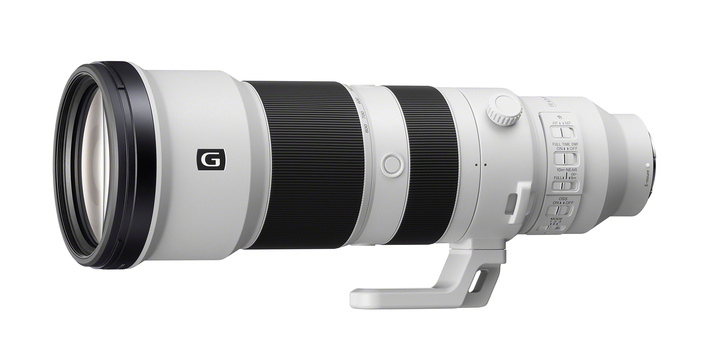 White and black telephoto lens with focus ring and depth-of-field scale markings.