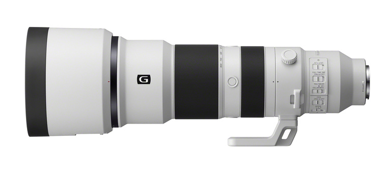 Side profile view of a white telephoto lens with black accents and control rings.