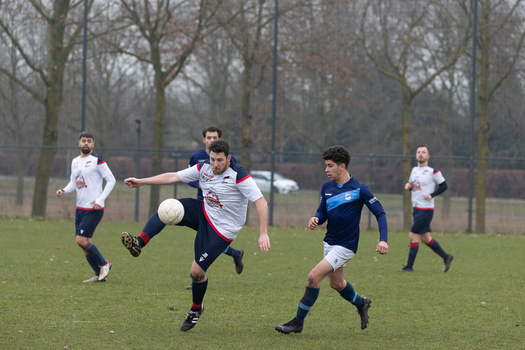 Youth soccer players competing for the ball during a match on a grass field.