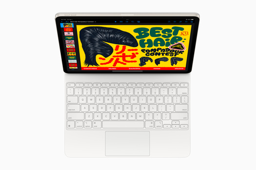 Overhead view of a tablet displaying colorful graphic design with a white keyboard attached below it.
