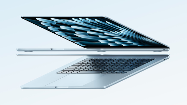 Two silver laptop computers displayed open at angles against a light blue background.