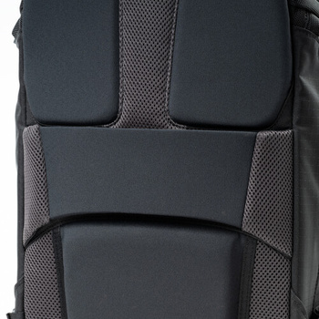 Close-up of a camera bag's back panel showing padded black neoprene and gray mesh material with segmented compartments.